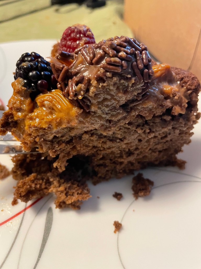 Cake slice with brigadeiro, dulce de leche, and fruit