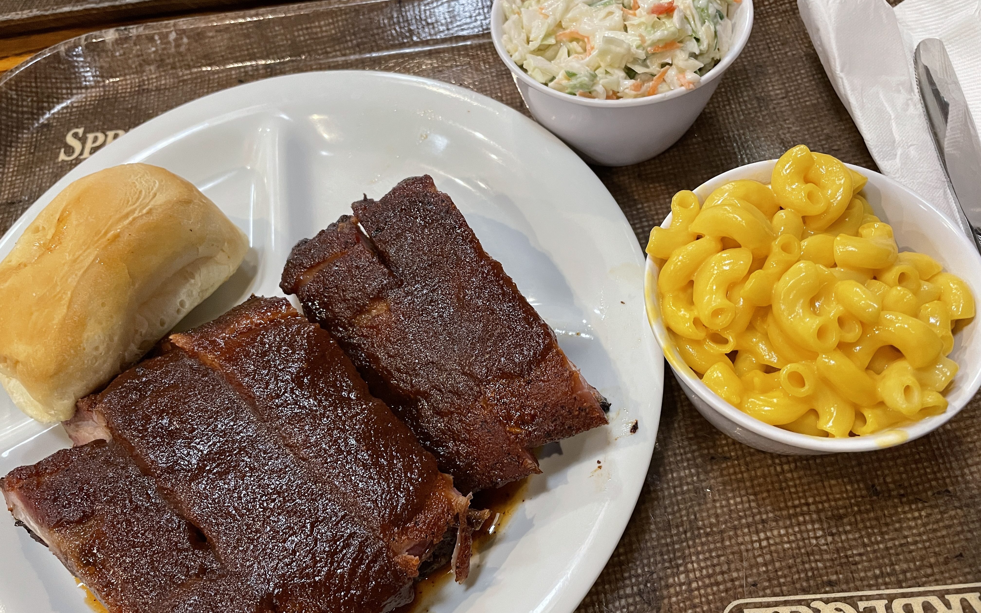 Baby back ribs with mac and cheese, coleslaw, and dinner roll